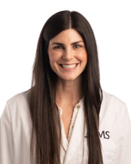 Mary Kate Clarkson, Pharm.D., BCACP, CDCES Professional headshot of Mary Kate Clarkson, Pharm.D., in her white coat.