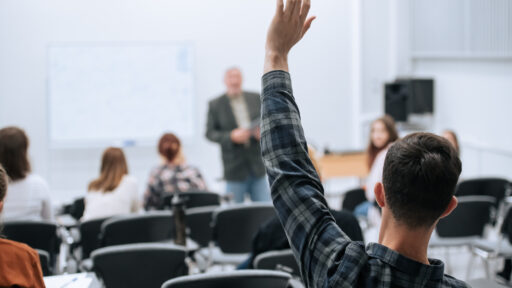A famous professor has arrived at the university to conduct a special lesson, the student pulls his hand up to ask him a question.