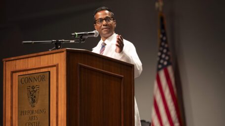 Ashok Philip, Ph.D., presents at a podium
