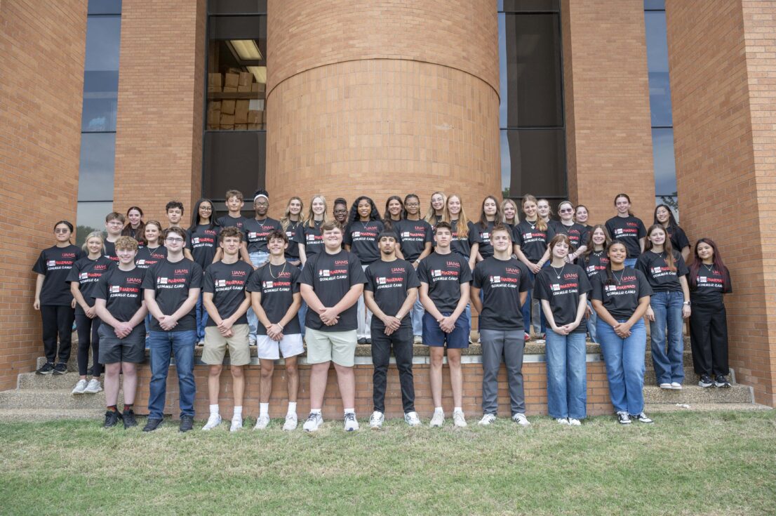 A large group of students wearing matching black shirts that say 